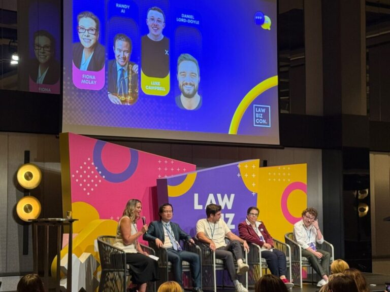 Panel discussion at Law Biz Con 2025 featuring legal industry speakers on stage